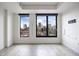 Bright living room with light hardwood floors and expansive windows offering city views at 1750 Wewatta St # 1536, Denver, CO 80202