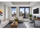 Bright living room with a comfortable seating area and a great view of the city skyline from large windows at 1750 Wewatta St # 1536, Denver, CO 80202