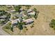 Aerial view of multiple residences with mature trees, lush greenery, and scenic mountain vistas in the background at 10985 Ambush Rock, Littleton, CO 80125
