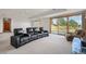 Finished basement with sliding glass doors, media center, and theater seating at 10985 Ambush Rock, Littleton, CO 80125