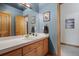 Bathroom with wooden cabinets, white tile countertops, and decor at 10985 Ambush Rock, Littleton, CO 80125