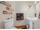 Charming powder room features pedestal sink, decorative towels, and artistic wall decor at 10985 Ambush Rock, Littleton, CO 80125