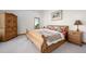 Comfortable bedroom boasts soft carpet, natural light, and traditional furnishings at 10985 Ambush Rock, Littleton, CO 80125