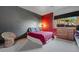 A brightly colored bedroom featuring grey accent walls and a scenic view from the window at 10985 Ambush Rock, Littleton, CO 80125