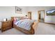 Well-lit bedroom with soft carpet, wood furnishings, and backyard view at 10985 Ambush Rock, Littleton, CO 80125