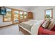Large bedroom with wood bed frame, TV, and exterior view at 10985 Ambush Rock, Littleton, CO 80125
