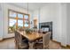 Bright dining room featuring a fireplace, wood floors, large window, and a classic chandelier at 10985 Ambush Rock, Littleton, CO 80125