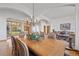 Elegant dining room featuring arched ceilings, hardwood floors, and adjacent living room space at 10985 Ambush Rock, Littleton, CO 80125