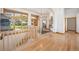 Spacious entryway showcasing hardwood floors, natural light, and stairway with wood banister at 10985 Ambush Rock, Littleton, CO 80125