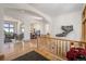 Bright foyer with gleaming hardwood floors, arched doorways, staircase, and dining room at 10985 Ambush Rock, Littleton, CO 80125