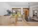 Bright foyer with gleaming hardwood floors, stone tiled entry, staircase, and windows at 10985 Ambush Rock, Littleton, CO 80125