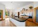 Bright kitchen with granite island, stainless steel appliances, and wood floors at 10985 Ambush Rock, Littleton, CO 80125