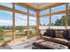 Bright living room with plentiful windows, plush seating, and stunning views at 10985 Ambush Rock, Littleton, CO 80125