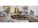 Open living room featuring plush seating, stylish decor, and a view to the front entrance at 10985 Ambush Rock, Littleton, CO 80125