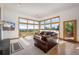 Inviting living room with fireplace, plush seating, and expansive windows offering scenic views at 10985 Ambush Rock, Littleton, CO 80125