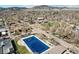 Bright aerial photograph of residential neighborhood near pool and school with mountain backdrop at 1927 Pine St # B, Boulder, CO 80302