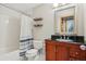 Well-lit bathroom features a shower over bath and a wooden vanity with black countertop at 1927 Pine St # B, Boulder, CO 80302