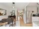 Bright dining room adjacent to kitchen, features hardwood floors, neutral paint, and modern lighting at 1927 Pine St # B, Boulder, CO 80302