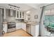 Well-lit, modern kitchen features stainless appliances, granite countertops, and view to outdoor patio at 1927 Pine St # B, Boulder, CO 80302