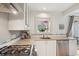 Bright kitchen features stainless appliances, granite countertops and window to outdoors at 1927 Pine St # B, Boulder, CO 80302
