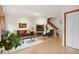 Comfortable living room with a fireplace, wood floors and staircase at 1927 Pine St # B, Boulder, CO 80302