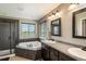 Bathroom features a luxurious soaking tub, walk-in shower, and double vanity sinks at 15352 E 117Th Ave, Commerce City, CO 80022