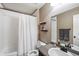 Standard bathroom with a shower-tub combo, white tile surround, neutral colors, and updated fixtures at 15352 E 117Th Ave, Commerce City, CO 80022