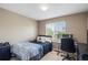 Comfortable bedroom with a black bed frame, desk, and bright window at 15352 E 117Th Ave, Commerce City, CO 80022
