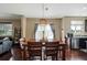 Dining room with wooden table, chairs, and view of outdoor scenery at 15352 E 117Th Ave, Commerce City, CO 80022