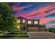 Stunning two-story home featuring a three-car garage, stone accents, and a charming front porch at 15352 E 117Th Ave, Commerce City, CO 80022
