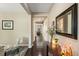 Inviting hallway with dark wood floors, neutral walls, and decorative accents at 15352 E 117Th Ave, Commerce City, CO 80022