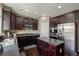 Well-equipped kitchen with stainless steel appliances, dark cabinetry, and a center island at 15352 E 117Th Ave, Commerce City, CO 80022