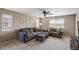 Comfortable living room with neutral tones, plush seating, and a ceiling fan for added relaxation at 15352 E 117Th Ave, Commerce City, CO 80022