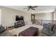 Open living area boasts a ceiling fan, neutral tones and carpeted floors at 15352 E 117Th Ave, Commerce City, CO 80022