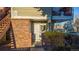 A sunny front entrance features brick accents and a white door for a charming welcome at 919 S Dawson Way # 7, Aurora, CO 80012