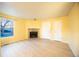 An open living area with light hardwood floors with a stone fireplace at 919 S Dawson Way # 7, Aurora, CO 80012
