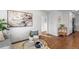 Living room features hardwood floors, a gray sofa, and open view to kitchen at 2389 Geneva St, Aurora, CO 80010