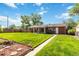 Expansive backyard offers a well-maintained lawn, mature trees, and a charming patio area, great for outdoor living at 5593 E Center Ave, Denver, CO 80246