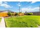 Lovely backyard with a wooden fence, lush green grass, and tasteful landscaping, perfect for Gathering enjoyment at 5593 E Center Ave, Denver, CO 80246