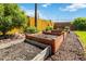 A backyard garden bed provides rich gardening opportunities, while the yellow fence encloses the space for added privacy at 5593 E Center Ave, Denver, CO 80246