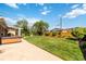 Large grassy backyard featuring a patio with a hot tub, wood fence, and mature trees at 5593 E Center Ave, Denver, CO 80246
