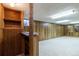 Spacious basement area features wood paneling, a bar, and ample room for recreation and storage at 5593 E Center Ave, Denver, CO 80246