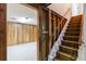 Basement entrance featuring wooden paneling and carpeted stairs at 5593 E Center Ave, Denver, CO 80246