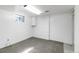 Finished basement room, featuring clean walls, neutral carpeting, a window, and ample storage space at 5593 E Center Ave, Denver, CO 80246