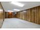 Spacious basement featuring wooden paneling and a retro bar at 5593 E Center Ave, Denver, CO 80246