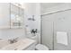 Bathroom featuring a frosted glass shower, bright vanity, and ample storage at 5593 E Center Ave, Denver, CO 80246