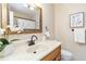 Bathroom featuring a decorative mirror, flower accents, and ample counter space at 5593 E Center Ave, Denver, CO 80246
