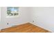 Bedroom with hardwood floors and a large window with a neighborhood view at 5593 E Center Ave, Denver, CO 80246