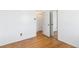 Bedroom featuring hardwood floors, mirrored closet, and a bright interior at 5593 E Center Ave, Denver, CO 80246