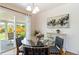Dining area with glass table, modern chairs, and view to an outdoor patio at 5593 E Center Ave, Denver, CO 80246